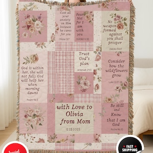 May include: A pink and cream throw blanket with floral patterns and inspirational quotes. The blanket features a patchwork design with various textures and the text "with Love to Olivia from Mom 12.25.2025".