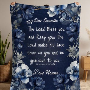 May include: Navy blue blanket with a floral design and the text "Dear Samantha, The Lord Bless you and Keep you; the Lord make his face shine on you and be gracious to you. Numbers 6:24-26 Love Nonna."