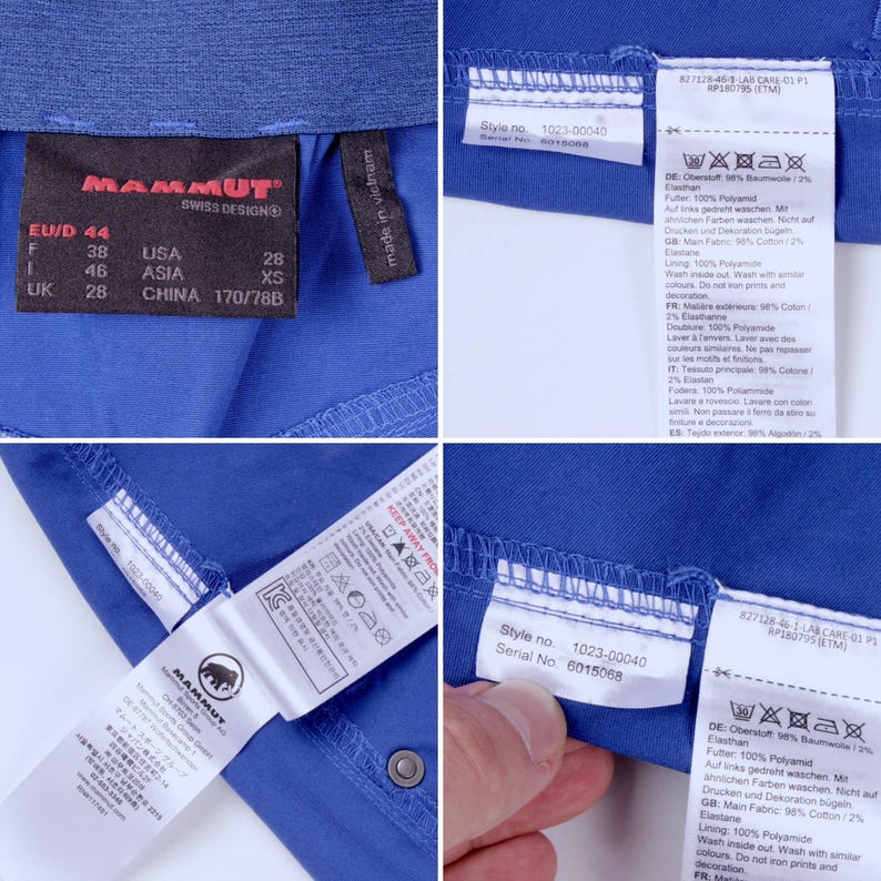 Puede incluir: Primer plano de tela azul con varias etiquetas. Las etiquetas muestran informaci&oacute;n de tallas, n&uacute;meros de estilo e instrucciones de cuidado. La marca "MAMMUT" es visible en una etiqueta. La tela parece ser parte de una prenda.
