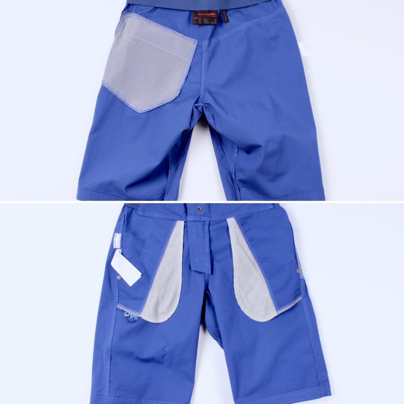 Puede incluir: Se muestran dos pares de pantalones cortos azules con forros de bolsillo grises. Los pantalones cortos tienen un dise&ntilde;o casual, con cintura y bolsillos. La tela parece duradera, adecuada para actividades al aire libre. Los pantalones cortos se muestran de frente y de espalda.