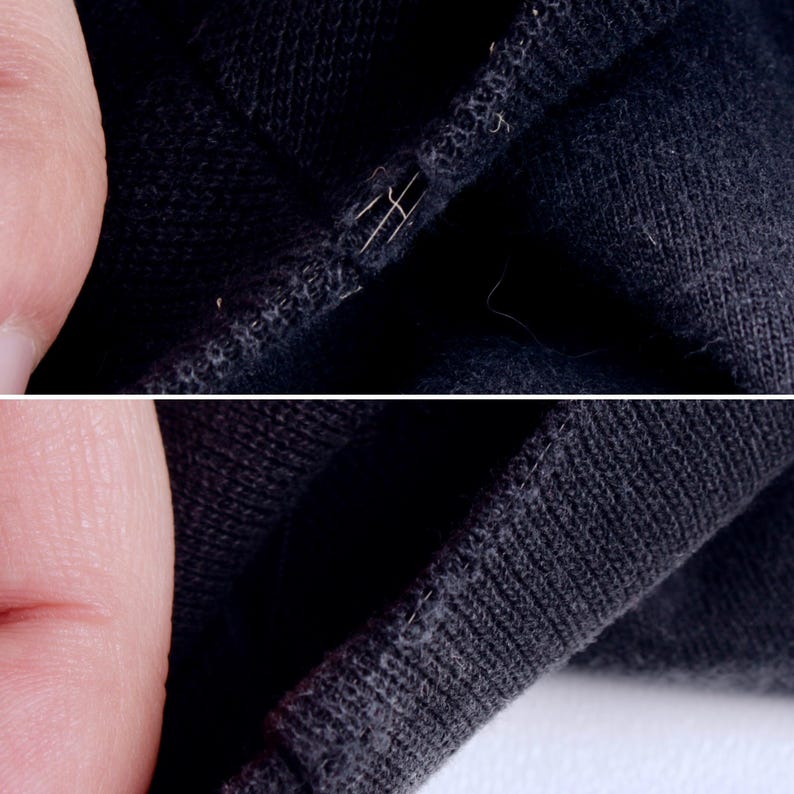 May include: Close-up of black fabric with visible stitching and a small tear. The fabric appears to be a knit material, with loose threads and a slightly worn texture. The image highlights the details of the textile.