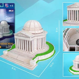 May include: A 3D puzzle of the Jefferson Memorial, a white building with a domed roof and columns, set on a green base. The assembled model measures 10 inches long, 9 inches wide, and 6 inches high. The box shows the completed puzzle and the words "3D Puzzle Jefferson Memorial".