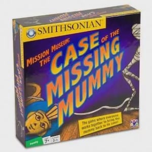 May include: A boxed board game titled "Mission Museum: The Case of the Missing Mummy" by Smithsonian. The box is primarily purple with yellow and orange text and features illustrations of a mummy and an Egyptian figure.