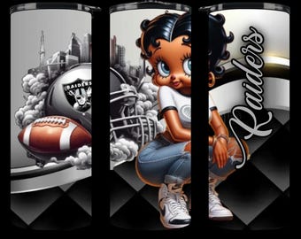May include: A black and white tumbler with a cartoon image of a woman wearing a white shirt and blue jeans. The tumbler has a black and white checkered pattern on the bottom and the word "Raiders" in white letters on the side. The woman is holding a football helmet.