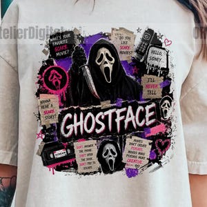 May include: A beige short-sleeve t-shirt featuring a graphic print of the Ghostface character holding a knife. The design includes the text GHOSTFACE, various movie-themed notes, a VHS tape, and purple and black abstract ink splatters.
