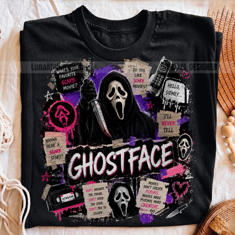 May include: A black t-shirt featuring a graphic print of the Ghostface character holding a knife. The design includes purple and pink accents, a vintage telephone, a VHS tape, and text including "What's your favorite scary movie?" and "Ghostface."