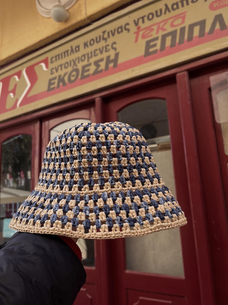 May include: A set of three ceramic mugs with a speckled, matte finish. The mugs are in shades of cream, light gray, and dark gray. Each mug has a simple, minimalist design and a rounded handle.