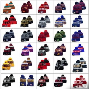 May include: A collection of 48 knitted beanies with team logos, including the Texans, Lakers, Bulls, Chiefs, Pirates, Yankees, Warriors, White Sox, Clippers, Saints, Nets, and more. The beanies are all black and white with a pom-pom on top.