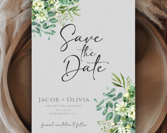May include: Save the date card with green foliage and white flowers. The card reads "Save the Date" with the names Jacob and Olivia, the date 07-24-25, and the location Sacramento, CA. The text "formal invitation to follow" is at the bottom of the card.