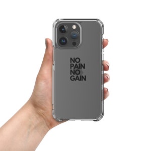 May include: Clear phone case with a gray backing and the words "NO PAIN NO GAIN" in black. The case has a clear, protective bumper around the edges and is designed for a smartphone.
