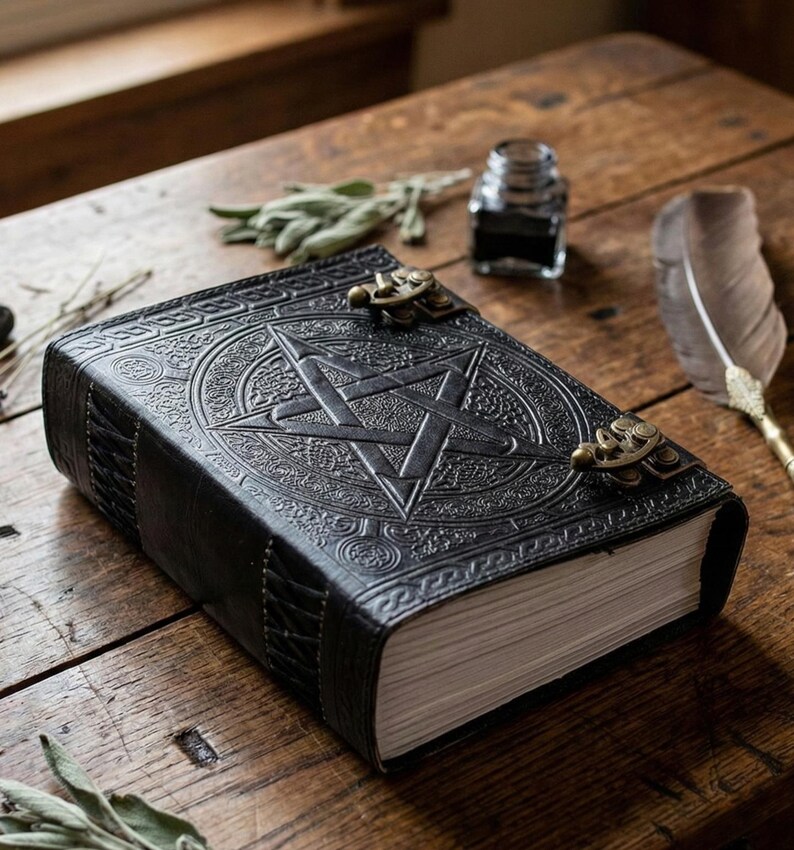 Puede incluir: Un diario de cuero negro con un dise&ntilde;o de pentagrama en relieve en la portada. El diario tiene cierres de lat&oacute;n y un borde decorativo. Las p&aacute;ginas son de color crema y el diario est&aacute; sobre una superficie de madera.