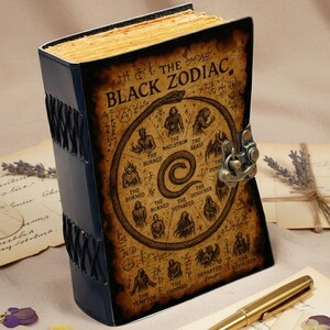 Medieval-style fantasy journal with zodiac sigil artwork and textured deckle-edge pages.