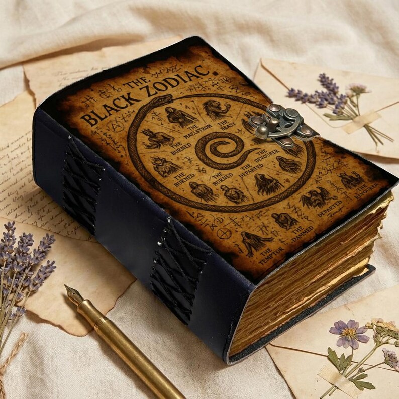 Dark academia grimoire notebook with weathered parchment paper and Black Zodiac design.