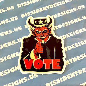 May include: A red and black sticker with a cartoon image of a devil wearing a Uncle Sam hat and pointing at the viewer. The sticker says "VOTE" in red letters.
