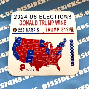 May include: A white sticker with a red, white, and blue map of the United States showing the results of the 2024 US Elections. The text on the sticker reads "2024 US Elections Donald Trump Wins 226 Harris Trump 312".