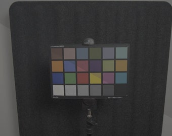 May include: A color chart with 24 squares, including shades of brown, blue, green, red, yellow, and gray. The chart is mounted on a black stand.