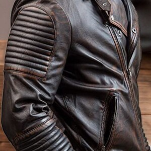 May include: A brown leather jacket with a zip fastening and a quilted design on the sleeves.