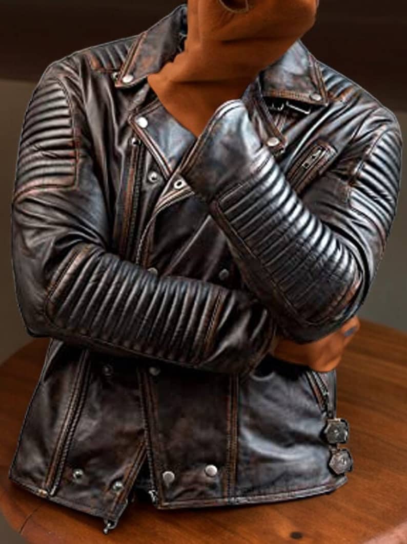 May include: A brown leather jacket with a zip fastening and a quilted design on the sleeves. The jacket has a distressed look and is made of genuine leather.
