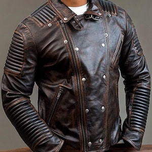 May include: A brown leather biker jacket with a zip fastening and multiple pockets. The jacket has a distressed look and features quilted detailing on the sleeves.