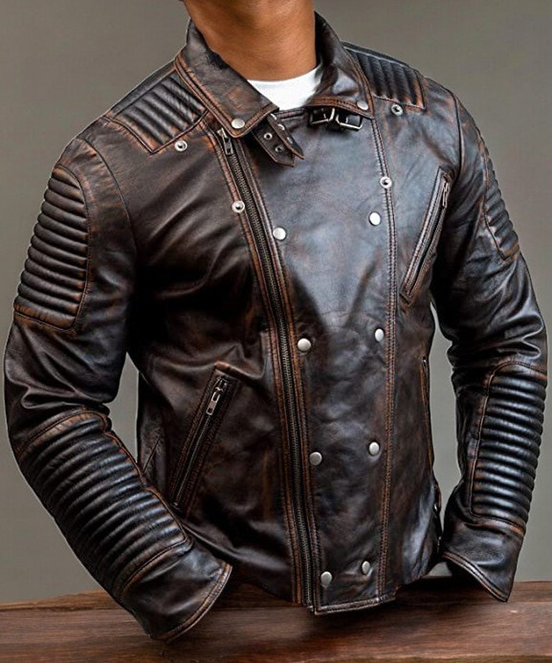 May include: A brown leather biker jacket with a zip fastening and multiple pockets. The jacket has a distressed look and features quilted detailing on the sleeves.