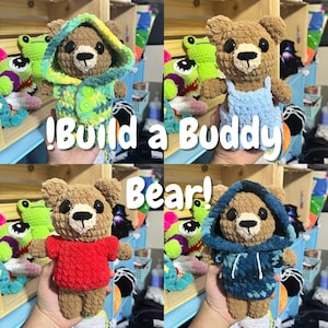 May include: Four crochet teddy bears in various outfits. One bear wears a green and yellow hooded jacket, another a blue dress, a third a red shirt, and the last a blue hoodie. The text "!Build a Buddy Bear!" is displayed.