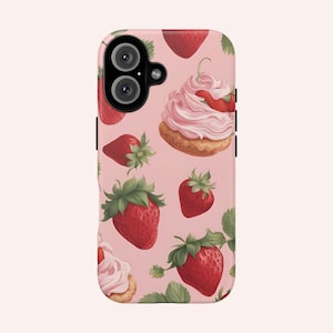 May include: A pink phone case with a pattern of strawberries and cupcakes. The case has a cutout for a camera lens.