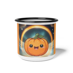 May include: White enamel mug with a black rim and an orange exterior. The mug features a cartoon pumpkin design with a smiling face, set against a celestial background. The pumpkin has a green stem and is surrounded by a golden halo.