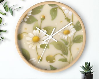 May include: Round wooden wall clock featuring a floral design with white daisies, yellow centers, and green leaves. The clock has white hands and a light beige background. The clock is mounted on a white wall.