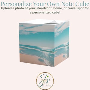 May include: A personalized note cube featuring a beach scene with turquoise water and a sandy shore. The cube has the text "Personalize Your Own Note Cube" and "Upload a photo of your storefront, home, or travel spot for a personalized cube!"