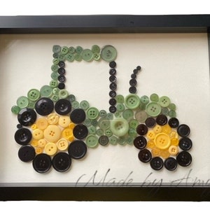 May include: A framed green and yellow button art piece depicting a tractor. The art piece is signed "Made by Amy".