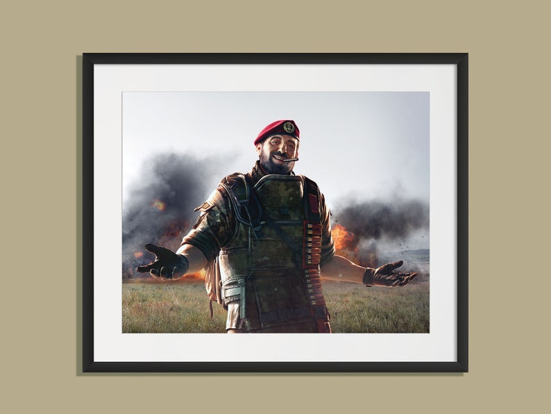 May include: A man in military fatigues and a red beret stands in front of a smoky explosion. He is smiling and has his arms outstretched.