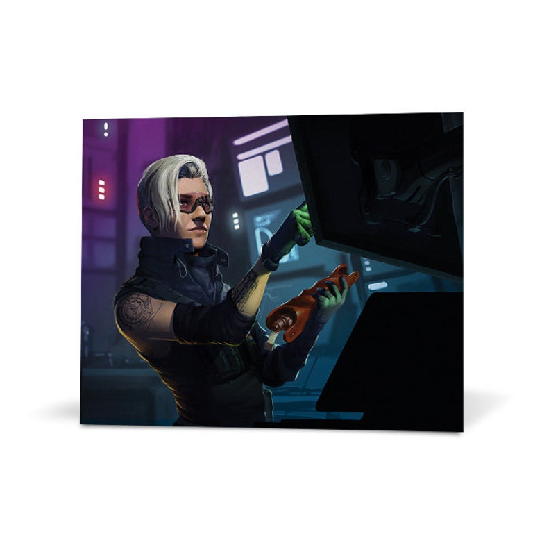 May include: A white-haired person wearing a black jacket and green gloves works on a computer with a red and orange object in their hand.