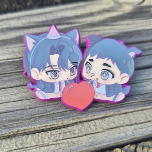 May include: Two cartoon figures with cat ears and a heart-shaped object. The figures are wearing suits and party hats. The heart is red with a pink outline. The figures are in shades of blue, pink, and white.