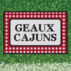 May include: A rectangular cross-stitch pattern featuring the black text GEAUX CAJUNS centered on a white background. The design is framed by a thick black border and an outer border consisting of a red and white checkered gingham pattern.