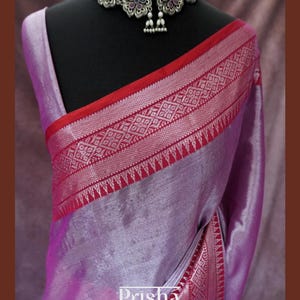 Tissue silk saree with sliver zari weaving and maroon contrast border. Available in Green, Sliver, Purple & Blue