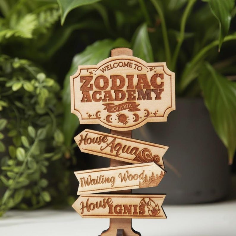 Op de afbeelding: Houtkleurige wegwijzer met de tekst "Welcome to Zodiac Academy Solaria". Onder de wegwijzer staan drie pijlen met de tekst "House Aqua", "Wailing Wood" en "House Ignis".