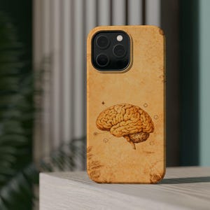 May include: A tan phone case featuring a detailed illustration of a human brain. The brain illustration is in shades of brown and tan, with a vintage, aged paper background. The case has a glossy finish and a camera cutout.
