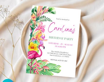 May include: A white invitation card with a watercolor floral design and a pink flamingo. The text reads "Caroline's Birthday Party" with event details. The card is set on a white plate with a beige background.
