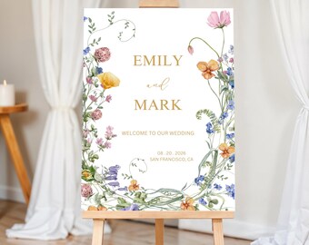 May include: Wedding welcome sign with a floral wreath design. The sign features the names "Emily and Mark" in gold lettering, the date "08.20.2026", and the location "San Francisco, CA".