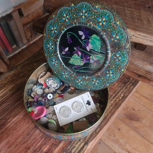 A antique metal tin full of antique buttons and sewing supplies- wooden spools & vintage buttons