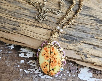 A vintage Rose necklace (possibly COSTUME jewelry) with 24 inch metal embossed chain- good/fair condition- super pretty & unique!