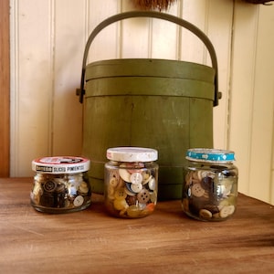 Set of 3! A old jars full of vintage buttons & wooden spools- 1960s and older- 2 old baby food jars and a  pimento jar! Good for crafting!