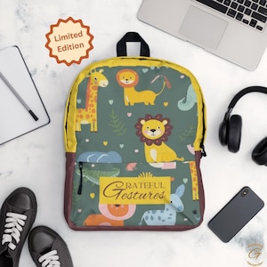 May include: A backpack with a jungle animal print, featuring giraffes, lions, and an elephant on a green background. The backpack has a yellow top, brown bottom, and the text "Grateful Gestures". A "Limited Edition" sticker is visible.