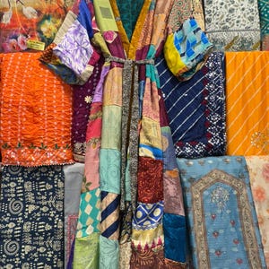 May include: A patchwork kimono robe with a variety of colorful fabric patterns. The robe has a V-neck, long sleeves, and a matching belt. The background features various textiles in shades of orange, blue, and purple.