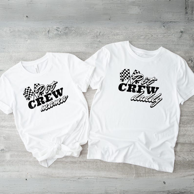 May include: Two white t-shirts with black checkered flags and text. One shirt says "Pit Crew mama" and the other says "Pit Crew daddy".