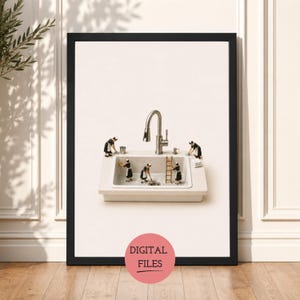 May include: A framed wall art print featuring a white kitchen sink with a silver faucet and five miniature figures dressed in black and white uniforms cleaning the basin. A small wooden ladder stands inside the sink, and a stack of white towels sits on the edge. The text DIGITAL FILES is printed in a pink circle at the bottom.