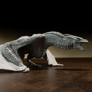 May include: A detailed, light grey dragon figurine with an open mouth and outstretched wings. The dragon has textured skin, sharp claws, and a long tail. The figurine is set on a brown surface with a dark background.