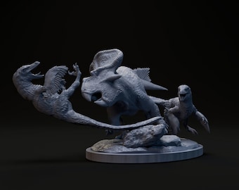 May include: A gray, sculpted model of a dinosaur with a frill on its head, being attacked by two smaller dinosaurs. The dinosaurs are posed on a gray, sculpted base.