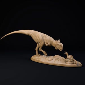 May include: A beige dinosaur sculpture depicting a large Allosaurus and a smaller dinosaur. The Allosaurus is positioned with its head directed towards the smaller dinosaur, which is on a rocky base. The sculpture is set against a black backdrop.