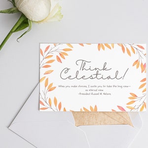 May include: A white card with the text "Think Celestial!" and a quote by President Russel M. Nelson, surrounded by orange and yellow watercolor leaves. The card is in a white envelope, with a white rose in the background.